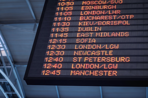 An airport timetable board with times and cities.